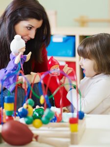 teacher and kid playing